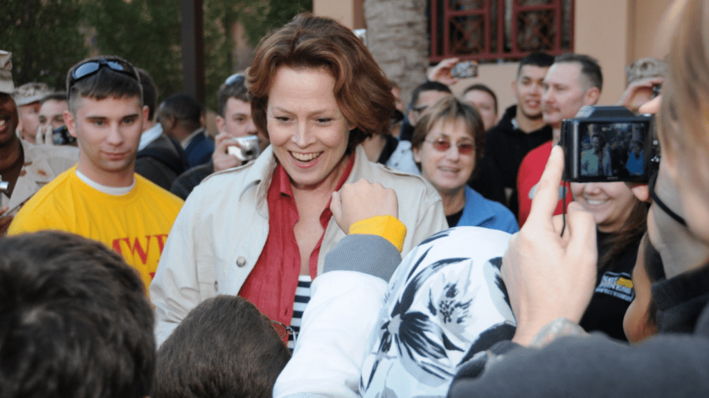 A person is surrounded by a crowd of people.