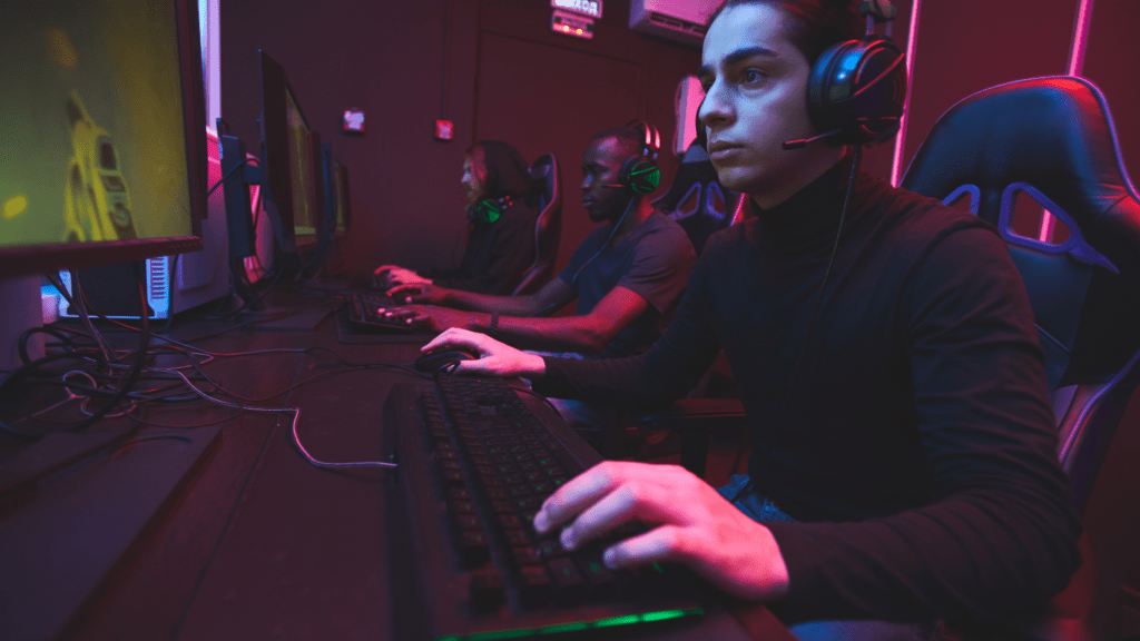 A person wearing headphones is playing a game on a computer.