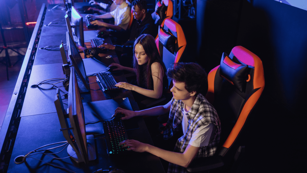 A person wearing headphones is playing a game on a computer.