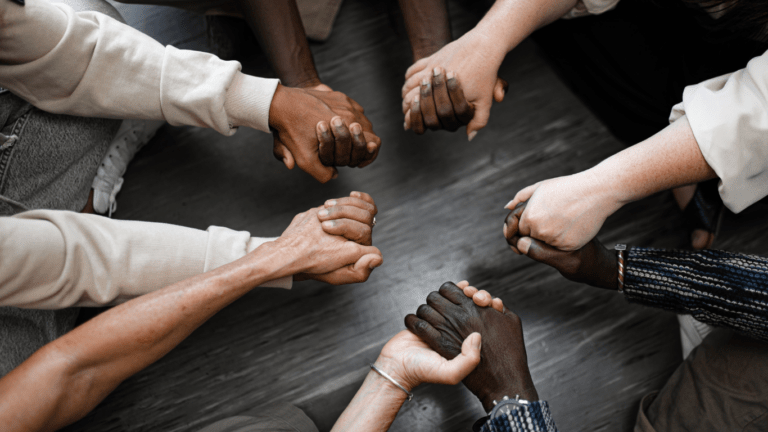 a group of people holding hands in a circle