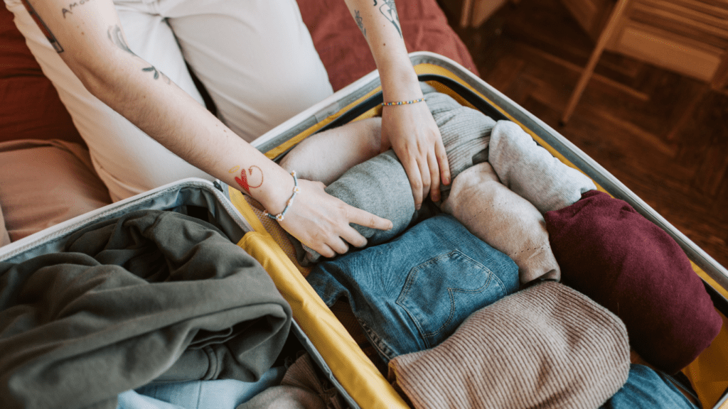 A person with a suitcase full of clothes.
