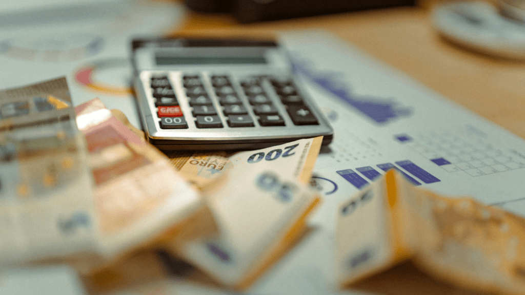 calculator and money on white background