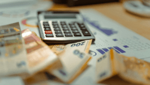 calculator and money on white background