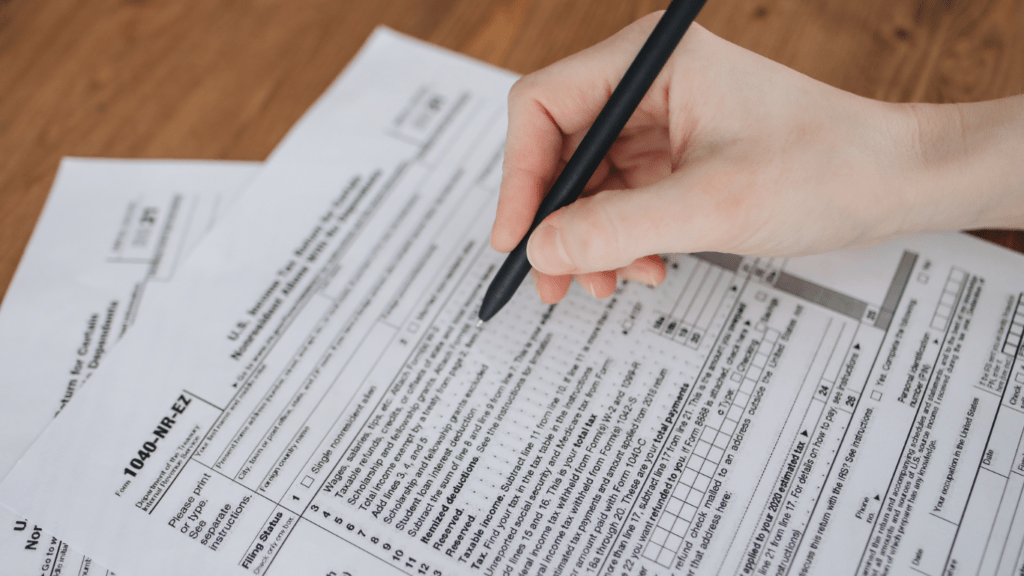 a person writing on a piece of paper