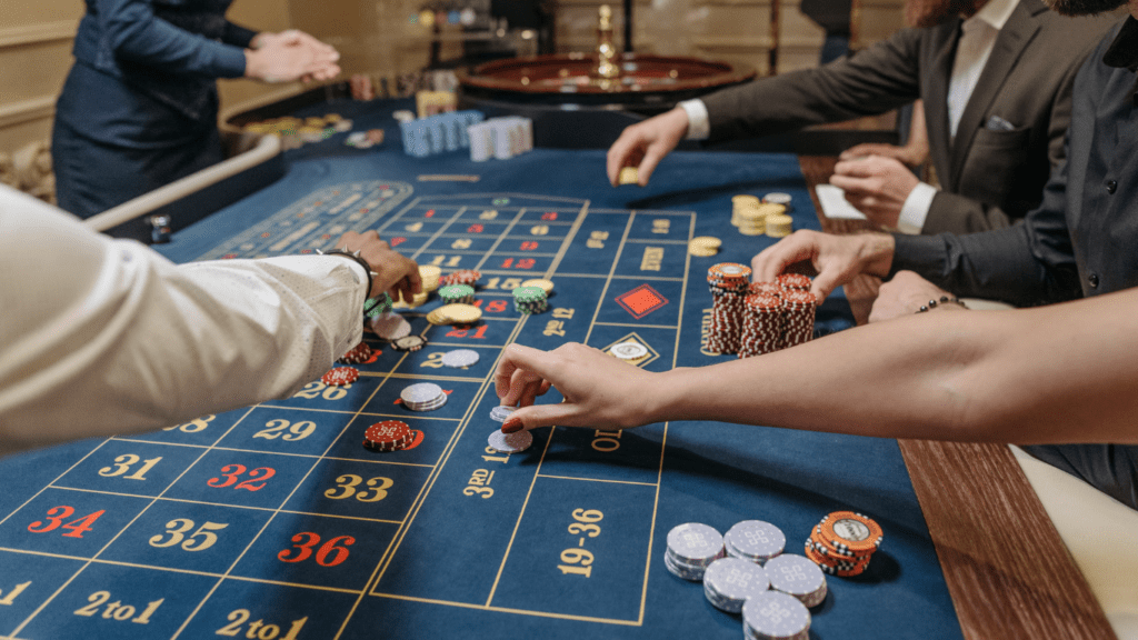 a group of people playing roulette at a casino table