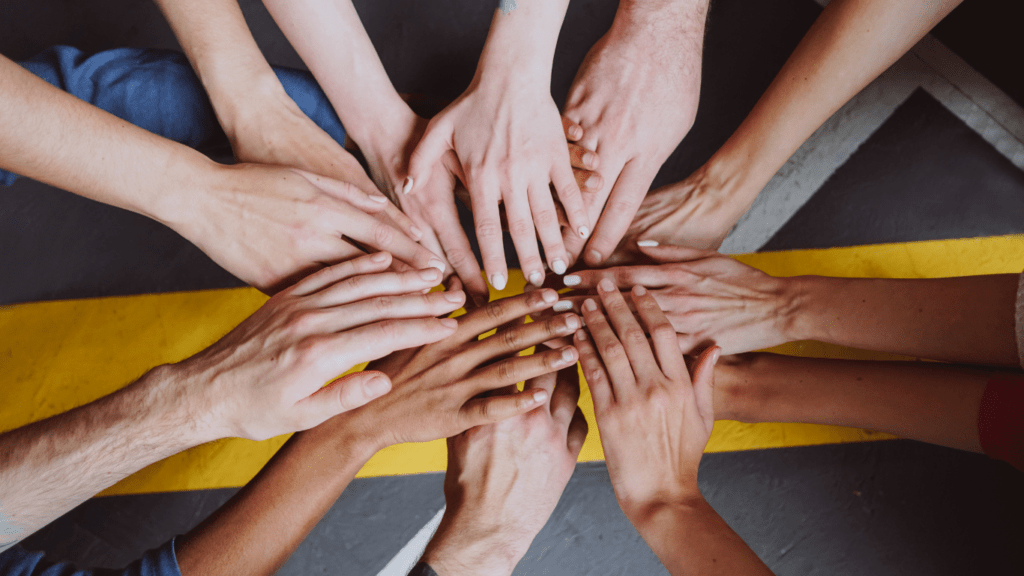 a group of people holding hands in a circle