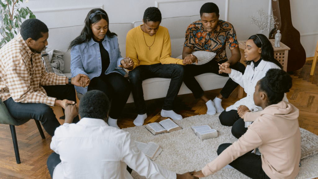 a group of people sitting on a couch talking to each other