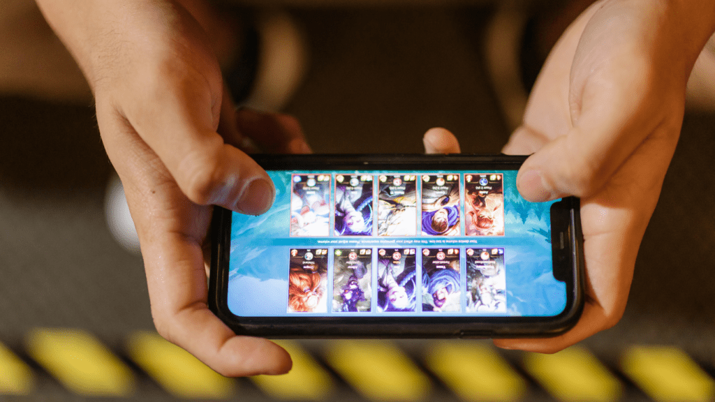 a person holding a cell phone with a game on it