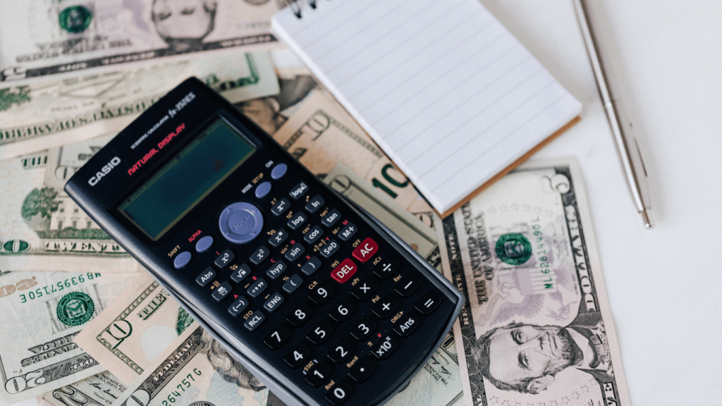 calculator and money on white background
