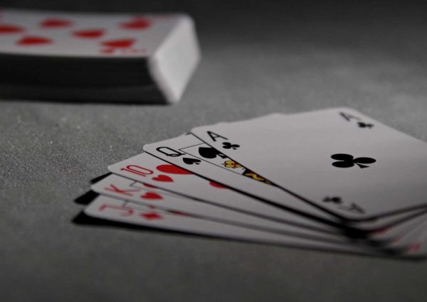 pexels-photo-279009-279009 Detailed view of playing cards displaying a winning poker hand in a dimly lit scene.